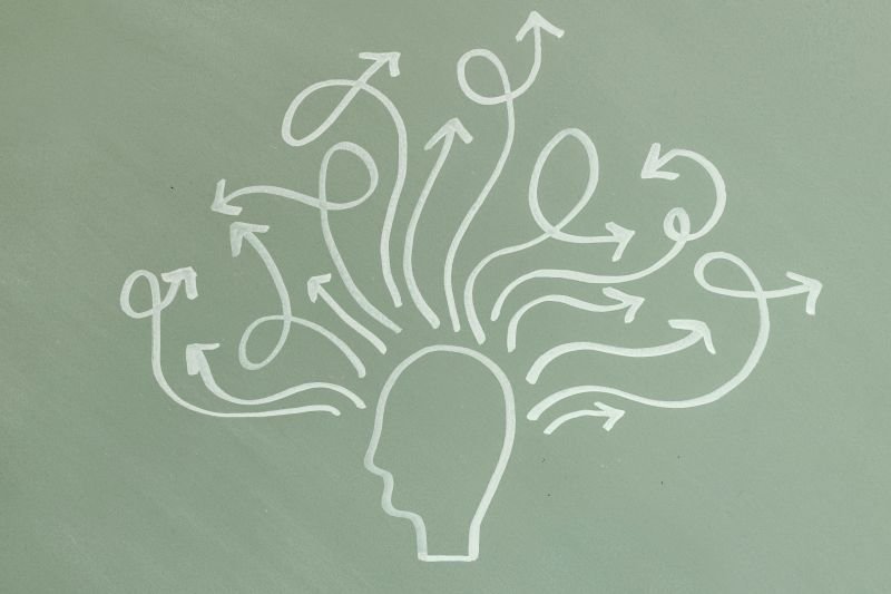drawing of a person with arrows coming out of their head, representing Neurodiversity and an Autistic person perhaps considering national clinical psychology service