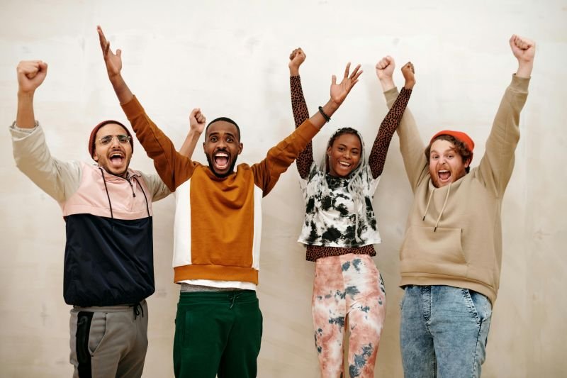 Picture showing 4 people cheering, representing the celebration of National Clinical Psychology Service being 10 years in private practice.