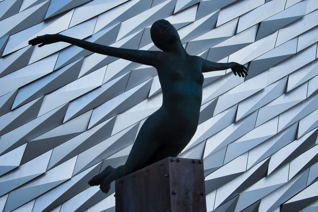 statue outside Titanic museum to link to the area re clinical psychologists for Belfast