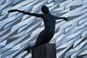 statue outside Titanic museum to link to the area re clinical psychologists for Belfast