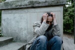 An image of a man looking upset and scared. He may be looking for help with complex PTSD, CPTSD from a clinical psychologist.